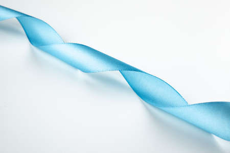 Shiny blue ribbon on white background with copy space