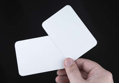 A man holding a white business card