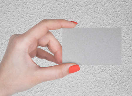 A woman holding a white business card