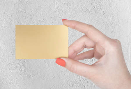 A woman holding a golden business cardの写真素材