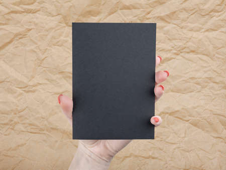 A woman holding black booklet. Identity templateの写真素材
