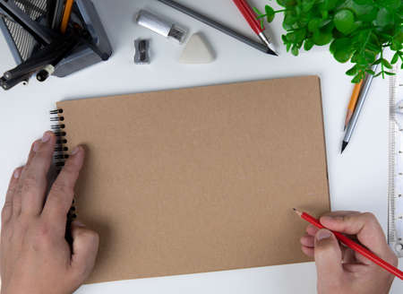 Human hand with pencil prepare to writing on notebookの写真素材