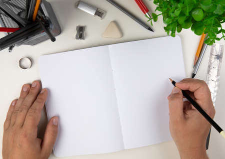 Human hand with pencil prepare to writing on notebookの写真素材
