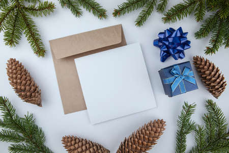 Christmas framework with evergreen fir tree, cones and white card for text
