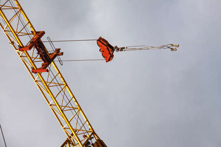 Tower crane at the construction site against the skyの写真素材