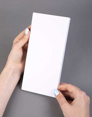 A woman holding white booklet. Identity template