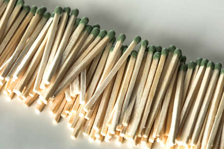Heap of matches with green heads on a white backgroundの写真素材