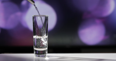 Bartender pouring up tequila into shot glass.の写真素材