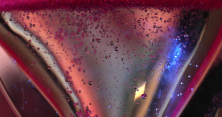 Bubbles Rising In A Glass With Pink Liquid