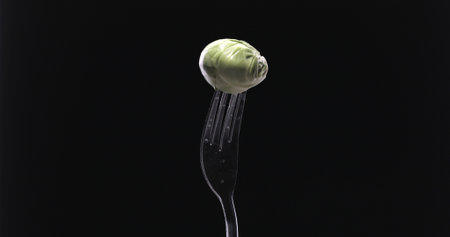Cabbage on a fork against black backgroundの写真素材