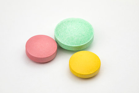 Multicolored tablets on white background. Health care conceptの写真素材