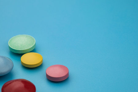 Multicolored tablets on blue background. Health care conceptの写真素材