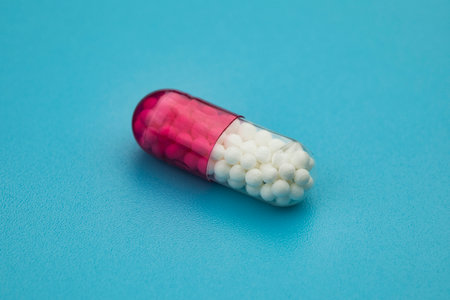 Medical capsule on blue background. Health care concept