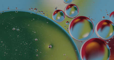 Oil bubbles on water abstract form in glass tankの写真素材