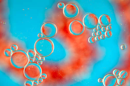 Oil bubbles on water abstract form in glass tankの写真素材