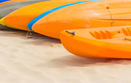 Many colorful kayaks orderly dock on the beautiful beachの写真素材