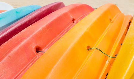 Many colorful kayaks orderly dock on the beachの写真素材