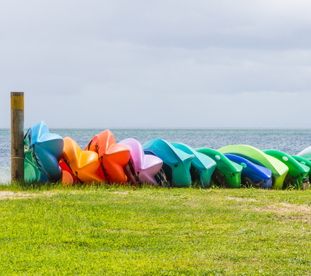 Many colorful kayaks orderly dock on the beach in the islandの写真素材