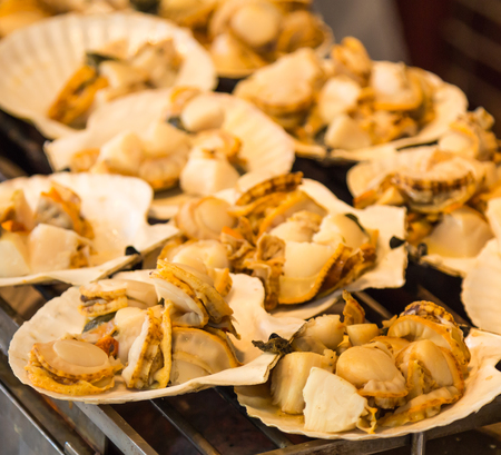 Grilled seafood on seashells at the marketの写真素材