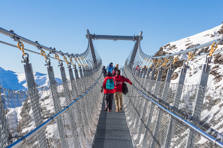 Engelberg, Switzerland - October 16, 2016: Unidentified tourists walk on Titlis Cliff Walk, suspension bridge at Mount Titlis in Engelberg, Switzerlandのeditorial素材