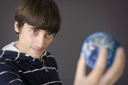 person that is holding the earth in his handの写真素材