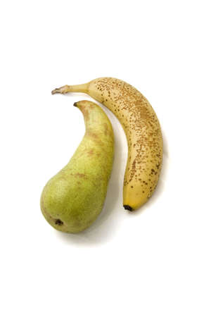A banana and pear on a white background.の写真素材