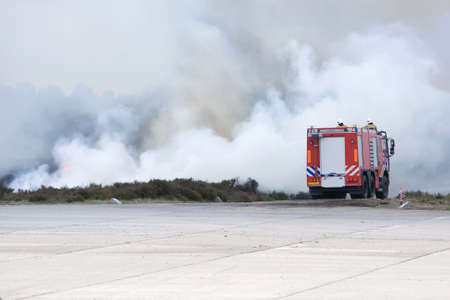A fire truck is fighhting the fire.