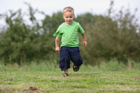 Young boy is walking in the park.の写真素材