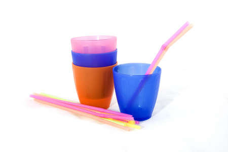 Different colored cups and straws on a white background.の写真素材