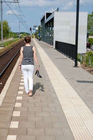 Woman is walking at the platformの写真素材