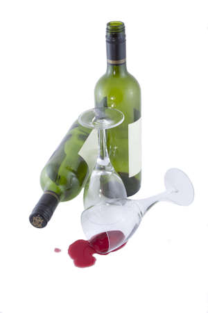 Empty wine glasses and bottles after a partyの写真素材