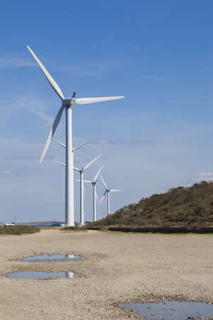 A couple windmills and a blue sky.
