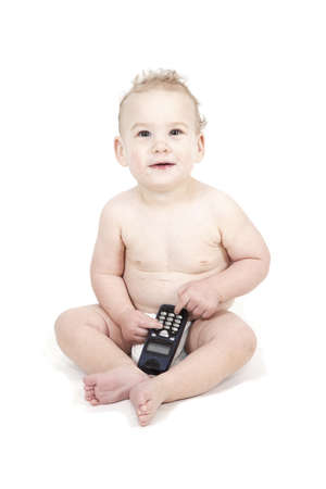 Young boy is using the phone on a white background.の写真素材
