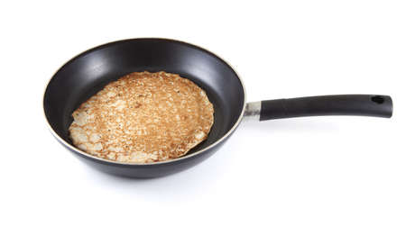 A pancake in a frying pan on a white background.の写真素材