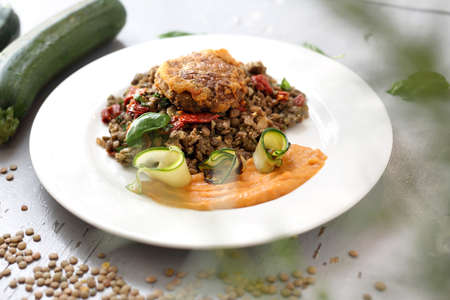 Lentils, carrot puree and grilled zucchini, vegetarian lunch. Horizontal frame.