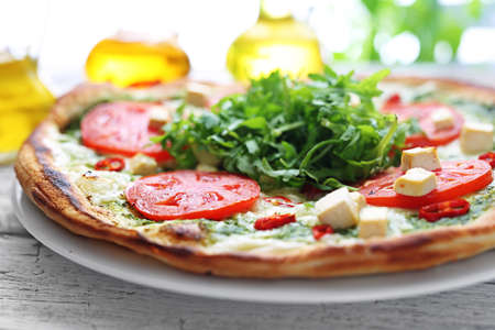 Pizza. Traditional Italian pizza on a thin crunchy dough with mozzarella, tomatoes, arugula.の写真素材