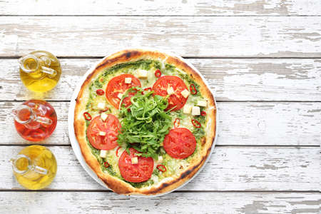 Pizza. Traditional Italian pizza on a thin crunchy dough with mozzarella, tomatoes, arugula.