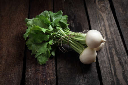 A composition of organic green vegetables straight from the garden. Vegetables on a wooden...
