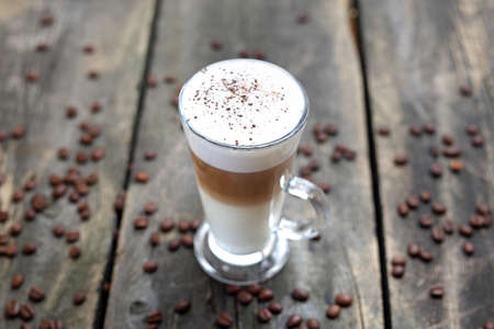 Coffee in a cup on a wooden background