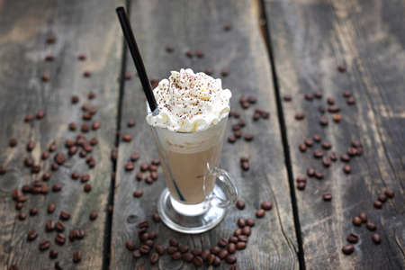 Coffee in a cup on a wooden background