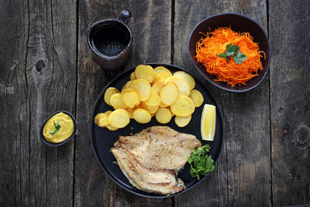 Dish served on a black plate on a wooden background.