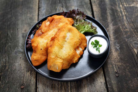 Dish served on a black plate on a wooden background.の写真素材