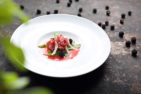Beef carpaccio served on raspberry and blackberry mousse. Appetizer