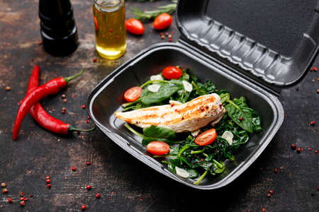 Takeaway food in a box. Ready prepared meal in a box. Tasty catering delivered to the office.