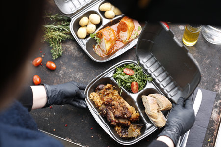 Takeaway food in a box. Ready prepared meal in a box. Tasty catering delivered to the office.の写真素材