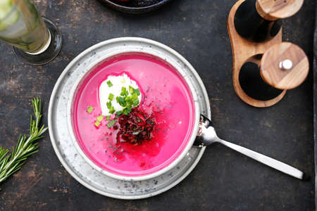 Beetroot soup with cream and chives. Food served on a plate, food styling, serving suggestions,...