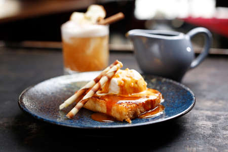 Apple pie with vanilla ice cream and caramel sauce. Appetizing sweet dessert. Culinary photography.