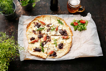 A flatbread with goat cheese, figs and red onion jam. Pizza with goat cheese, figs and red onion...