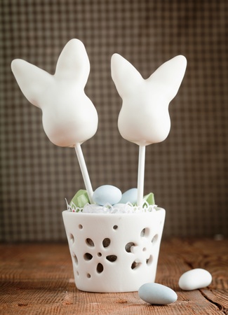 Happy Easter Cake pops with candy easter eggs on a wooden plateの写真素材