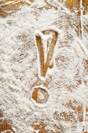 Flour Artwork With Food And Handprints, Fun background with the sign EXCLAMATION MARK and human handpints in scattered flour on a wooden tabletop.の写真素材